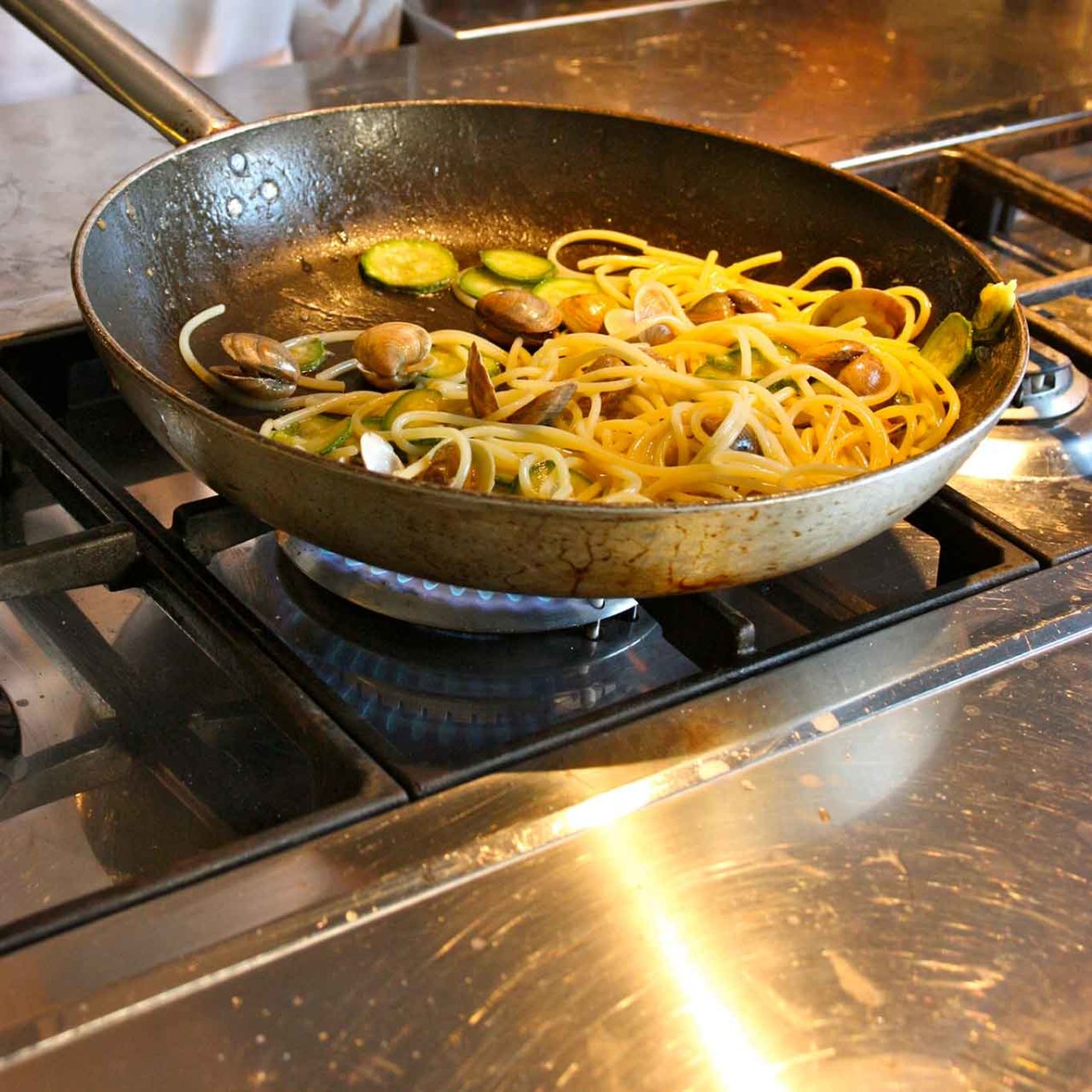 spaghetti con vongole e zucchine finitura in padella